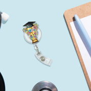Graduation Trophy Badge Reel – Teacher or Grad ID Holder – Floral Cap Clip – End of Year Gift – Academic Award Lanyard