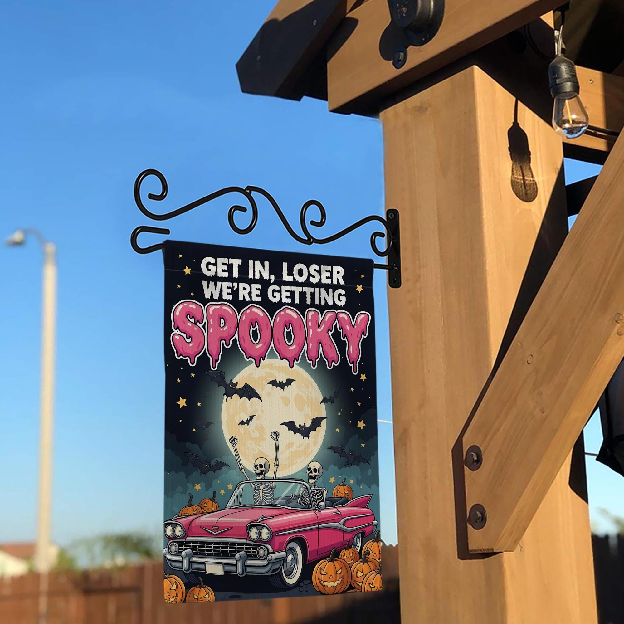 Funny Halloween Garden Flag: Spooky Skeletons in Pink Car